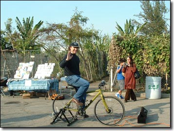 A bicycle-powered generator from the Post Carbon Institute provides electricity for the PA